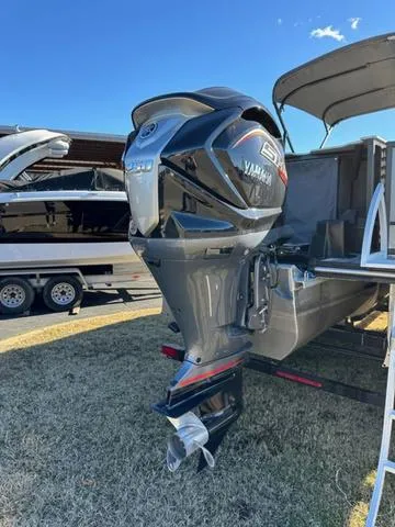 Slide: The Image of 2024 SunCatcher Fusion 322FC with Yamaha outboard motor on trailer. - 20