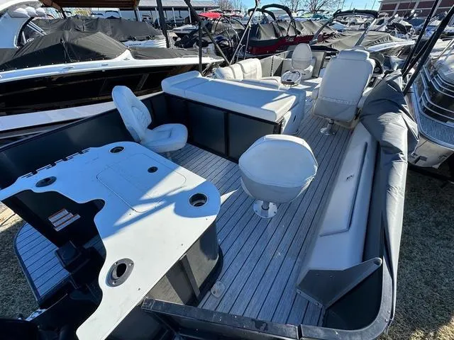 Slide: The Image of 2024 SunCatcher Fusion 322FC pontoon boat interior with seating and helm station. - 3