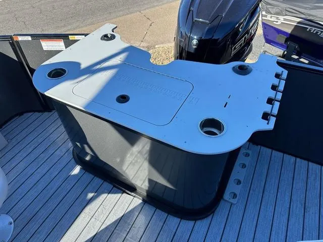 Slide: The Image of 2024 SunCatcher Fusion 322FC boat deck with motor and storage unit. - 4