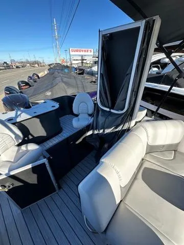 Slide: The Image of 2024 SunCatcher Fusion 322FC boat interior with seating and helm station. - 6