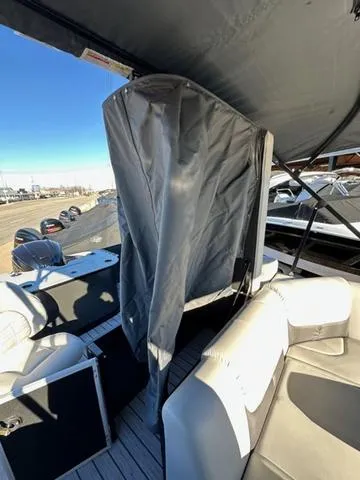 Slide: The Image of 2024 SunCatcher Fusion 322FC boat interior with seating and covered area. - 7