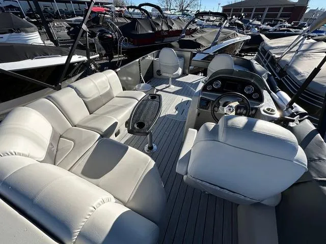 Slide: The Image of 2024 SunCatcher Fusion 322FC pontoon boat with spacious seating and modern dashboard. - 8