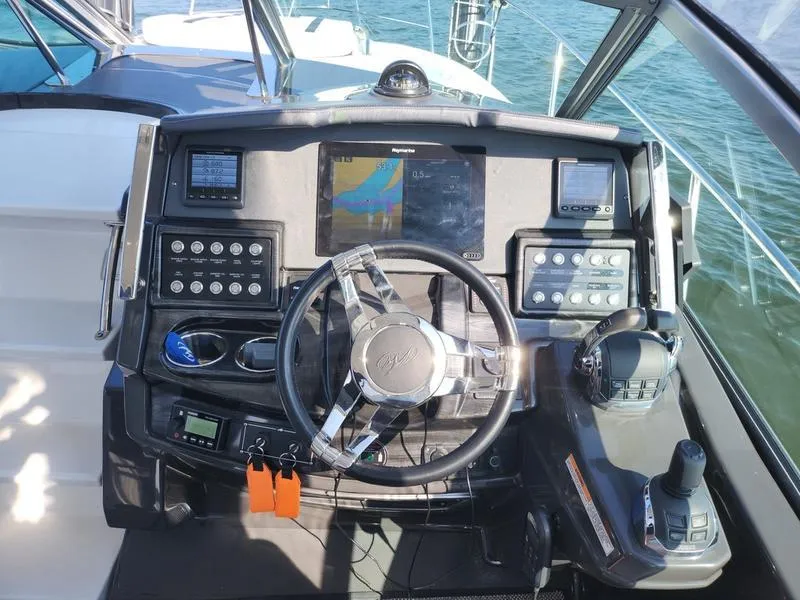 Slide: The Image of 2019 Monterey 335SY boat dashboard with advanced navigation controls and steering wheel. - 14