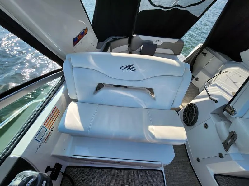 Slide: The Image of 2019 Monterey 335SY boat interior with white seating and water view. - 15