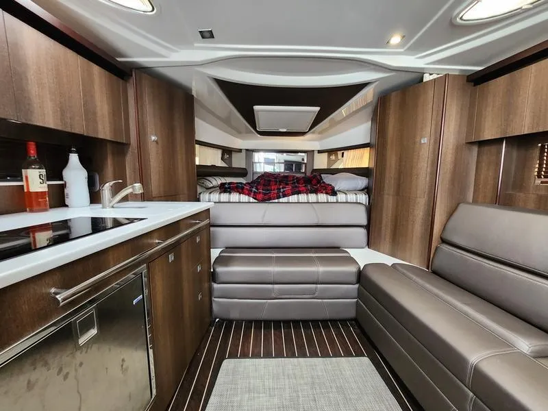 Slide: The Image of Luxurious interior of 2019 Monterey 335SY yacht with modern kitchen and cozy seating area. - 21