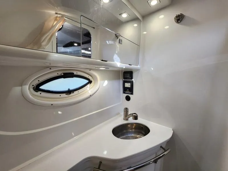 Slide: The Image of Luxurious bathroom in 2019 Monterey 335SY yacht with modern fixtures and oval window. - 24