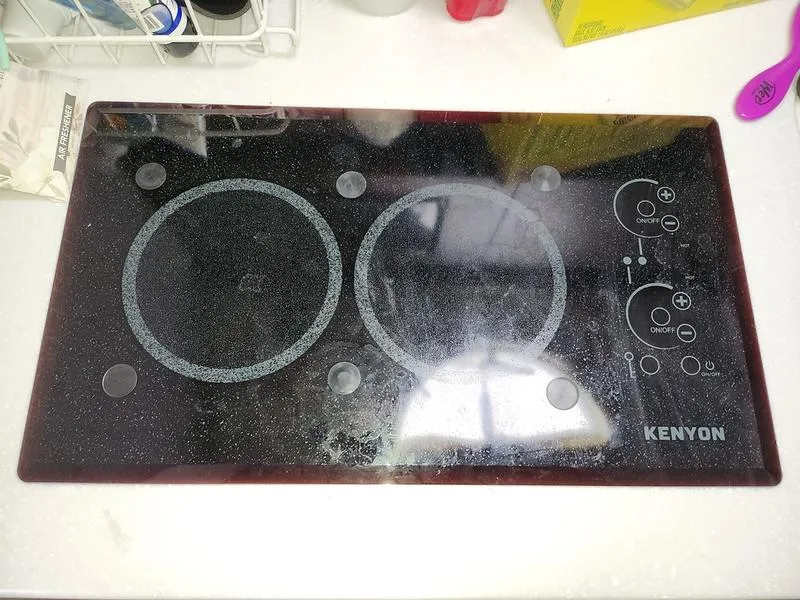 Slide: The Image of Kenyon glass cooktop on Monterey 335SY 2019 yacht, featuring dual burners and touch controls. - 28