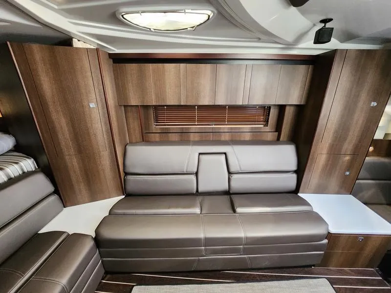 Slide: The Image of 2019 Monterey 335SY interior with sleek leather seating and modern wood paneling. - 36
