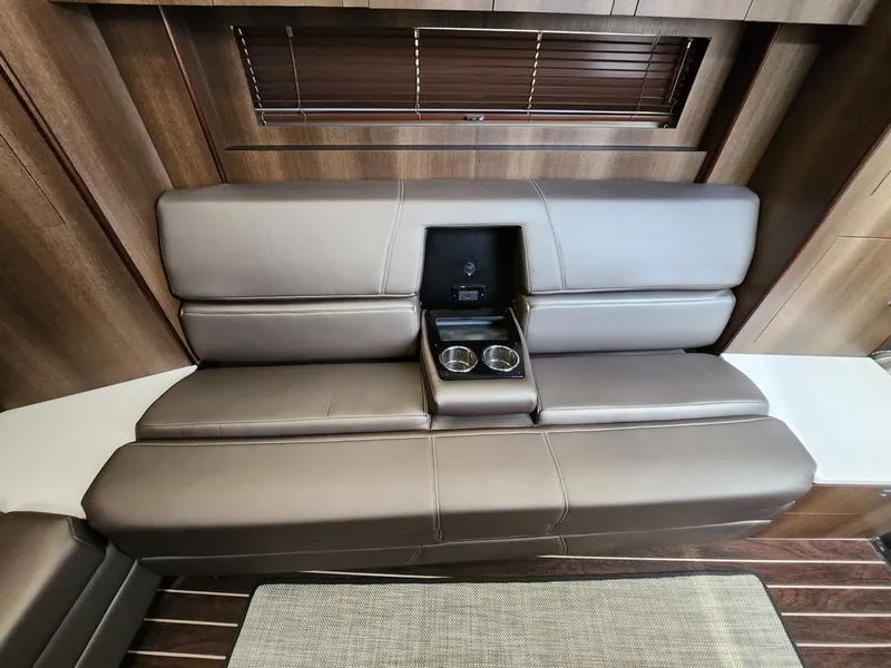 Slide: The Image of 2019 Monterey 335SY yacht interior with brown leather seating and cup holders. - 37