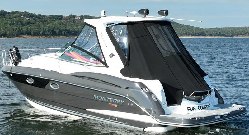 Slide: The Image of 2019 Monterey 335SY boat cruising on a lake with scenic background. - 4