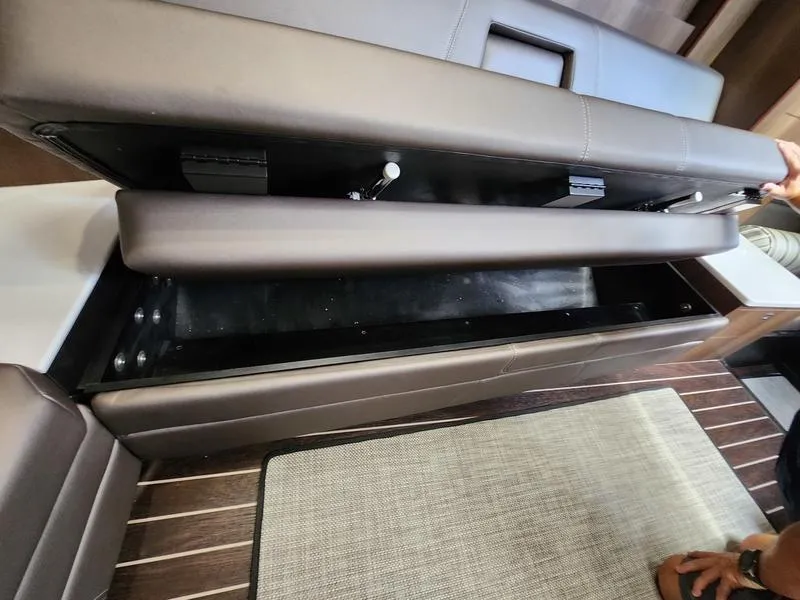 Slide: The Image of 2019 Monterey 335SY boat interior storage compartment with open seat cushion. - 40