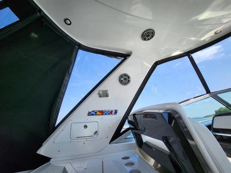 Slide: The Image of Interior view of 2019 Monterey 335SY boat with sleek design and nautical flags. - 48