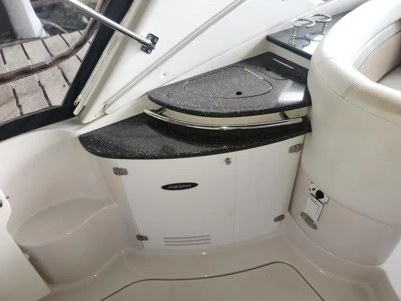Slide: The Image of 2007 Four Winns 358 Vista boat interior with black countertop and white cabinetry. - 12