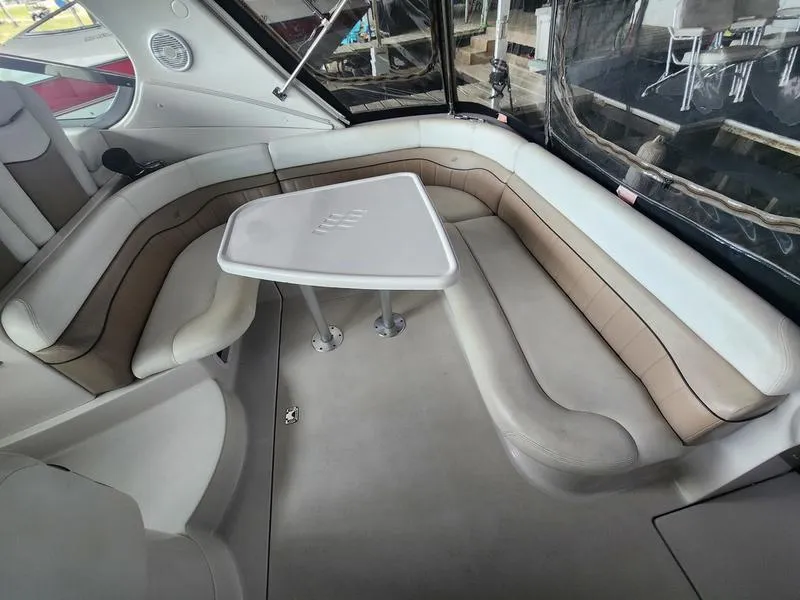 Slide: The Image of 2007 Four Winns 358 Vista boat interior with cushioned seating and a triangular table. - 13