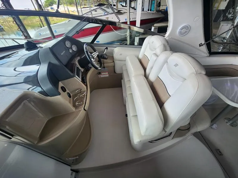 Slide: The Image of 2007 Four Winns 358 Vista boat cockpit with white leather seats and control panel. - 16