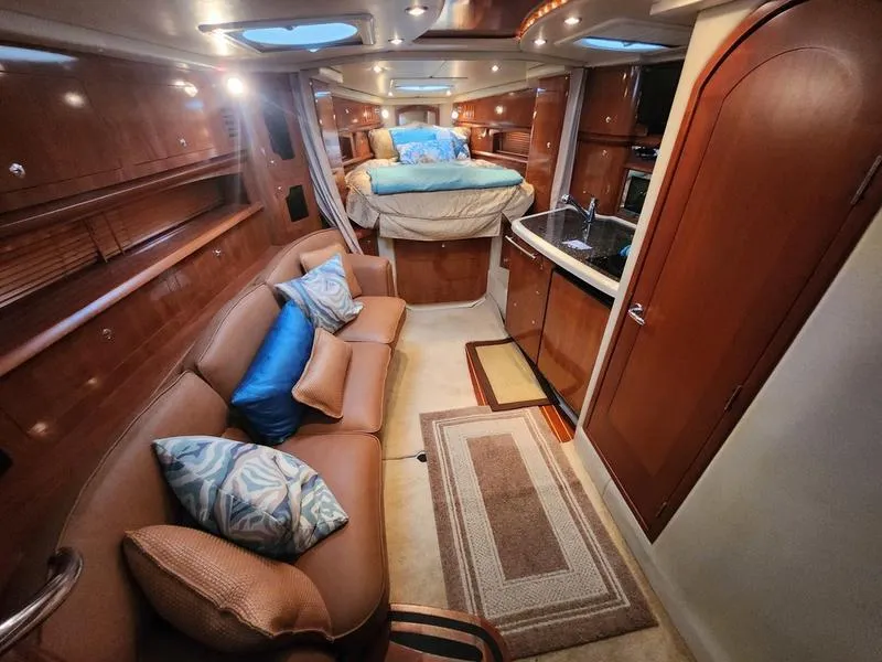 Slide: The Image of 2007 Four Winns 358 Vista interior with cozy seating, bed, and kitchenette. - 18