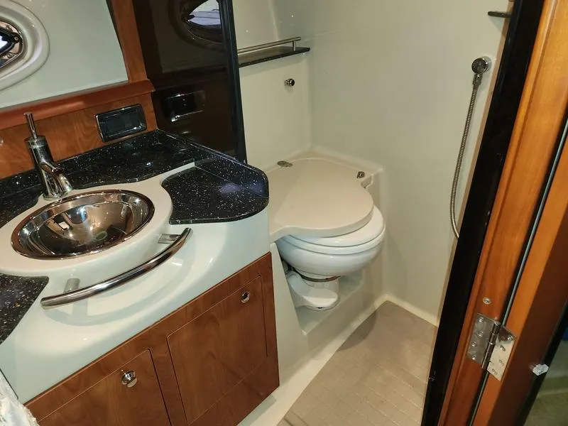 Slide: The Image of 2007 Four Winns 358 Vista boat bathroom with sink, toilet, and shower. - 24