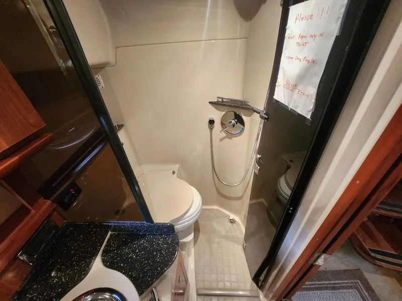 Slide: The Image of 2007 Four Winns 358 Vista bathroom with shower, toilet, and sink. - 25