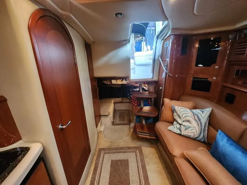 Slide: The Image of Interior of 2007 Four Winns 358 Vista yacht with cozy seating and wooden cabinetry. - 28