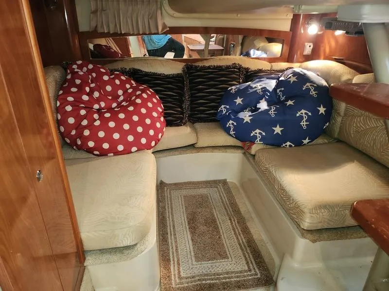 Slide: The Image of 2007 Four Winns 358 Vista cabin interior with cozy seating and decorative pillows. - 29