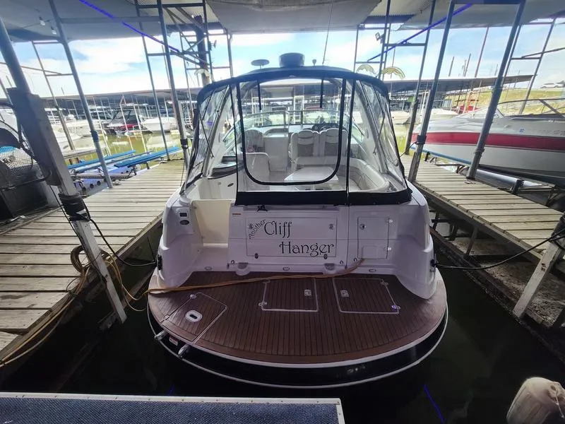 Slide: The Image of 2007 Four Winns 358 Vista boat docked, rear view with Cliff Hanger name. - 4