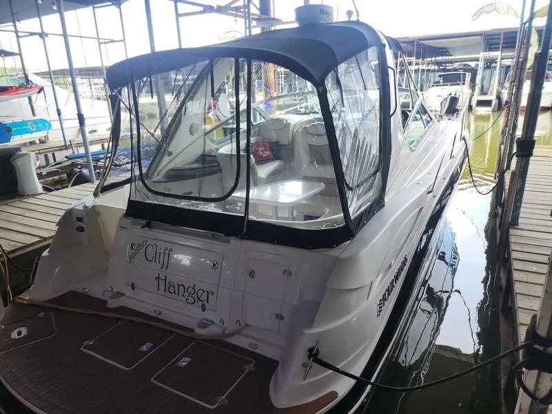 Slide: The Image of 2007 Four Winns 358 Vista boat docked, rear view with Cliff Hanger name. - 5