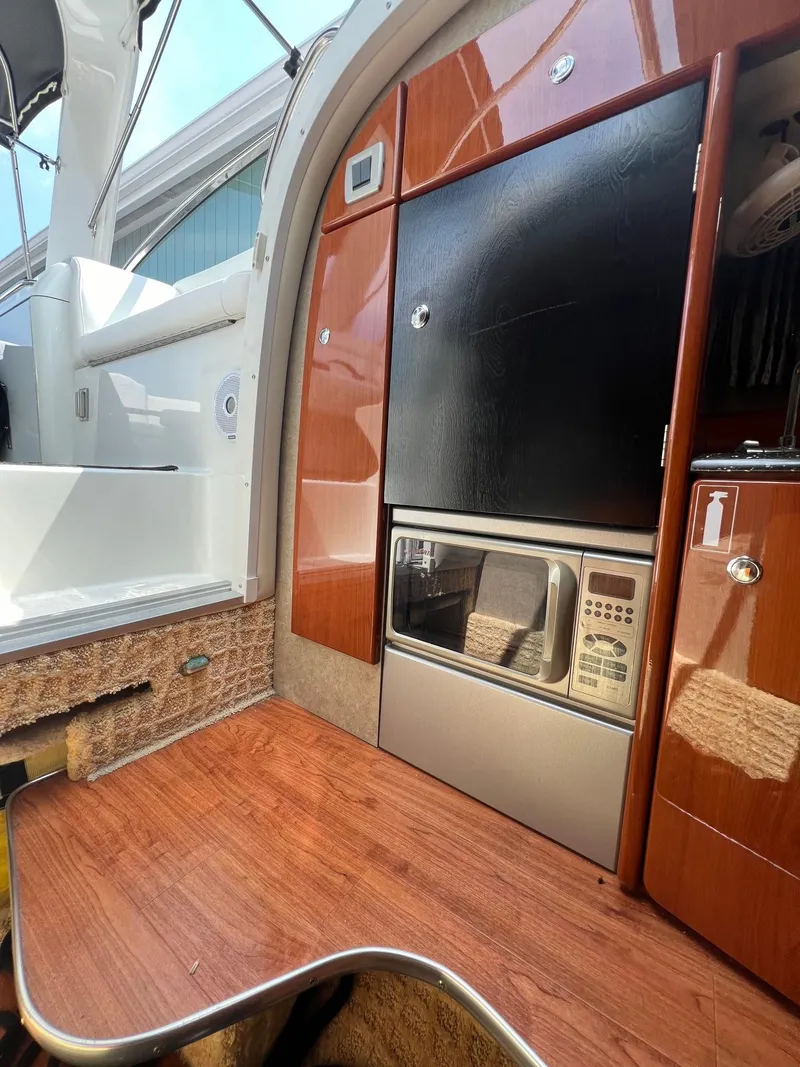 Slide: The Image of 2007 Formula 310SS boat interior with kitchenette and wood finish. - 12