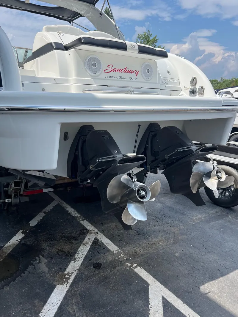 Slide: The Image of 2007 Formula 310SS boat stern with dual propellers in a parking lot. - 14