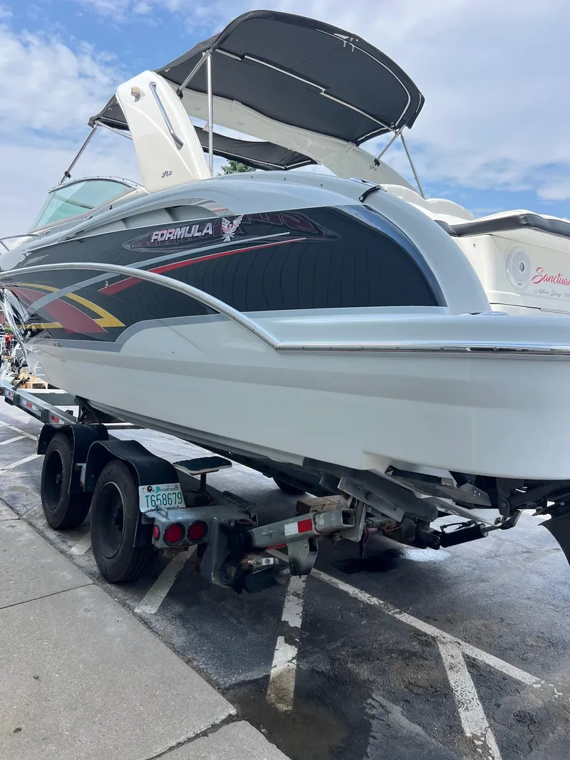 Slide: The Image of 2007 Formula 310SS boat on a trailer, parked outdoors. - 18