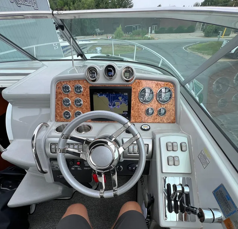 Slide: The Image of 2007 Formula 310SS boat dashboard with steering wheel, gauges, and navigation screen. - 3