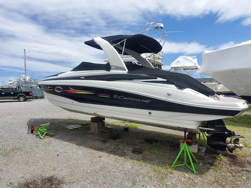 The Image of 2014 Crownline 285 SS boat on dry dock with black and white exterior. - 0