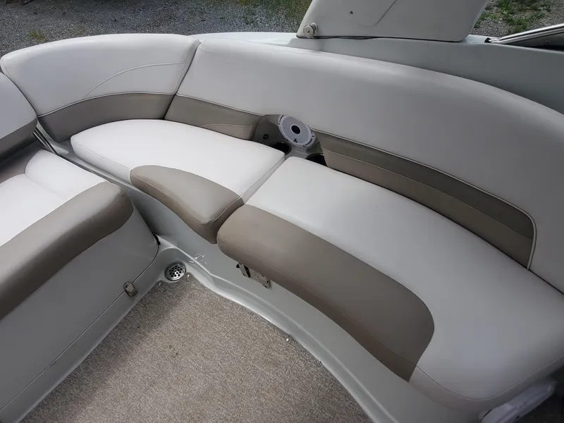 Slide: The Image of 2014 Crownline 285 SS boat interior with beige and white cushioned seating. - 10