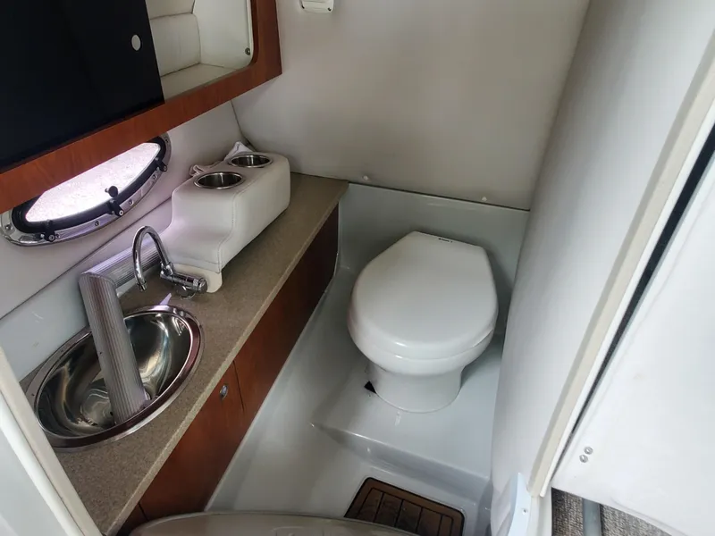 Slide: The Image of 2014 Crownline 285 SS boat bathroom with sink and toilet. - 12