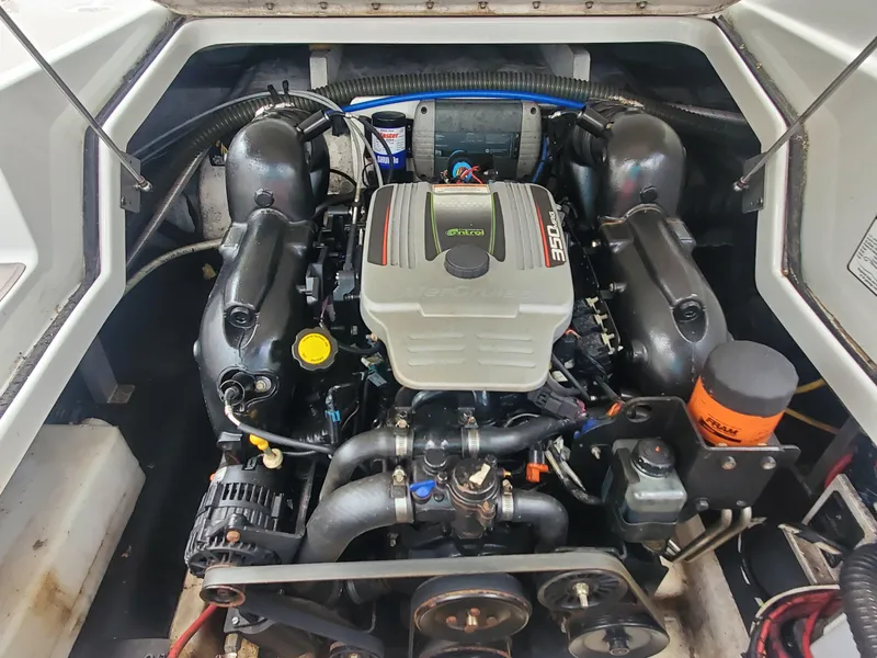 Slide: The Image of 2014 Crownline 285 SS boat engine compartment with a powerful inboard motor. - 13