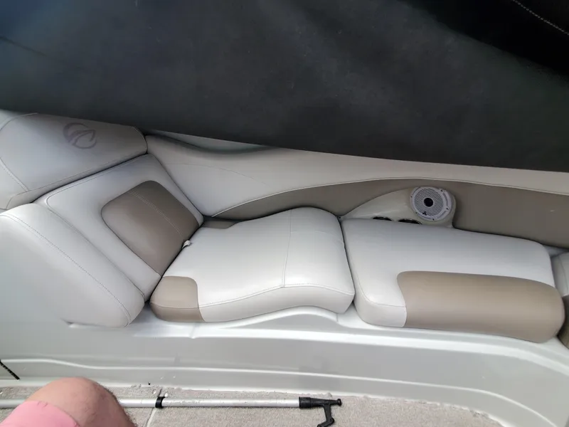 Slide: The Image of Interior seating of a 2014 Crownline 285 SS boat with beige and white upholstery. - 17
