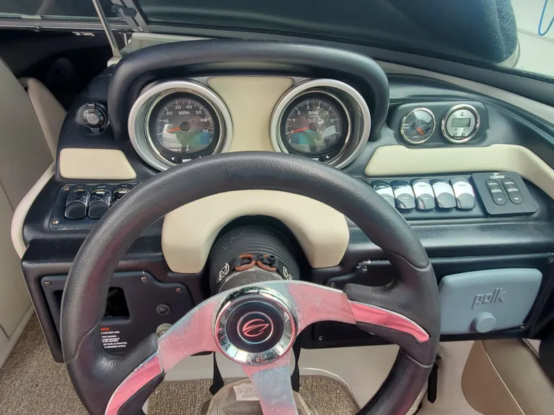 Slide: The Image of 2014 Crownline 285 SS boat dashboard with steering wheel and instrument panel. - 6