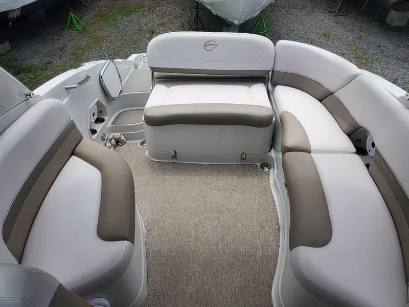 Slide: The Image of 2014 Crownline 285 SS boat interior with beige and white seating. - 7