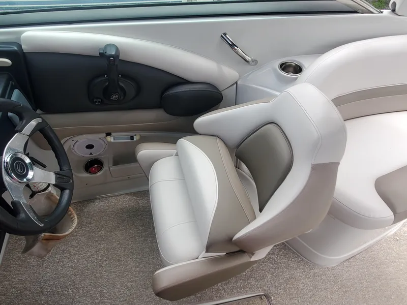 Slide: The Image of 2014 Crownline 285 SS boat interior with steering wheel and captain's chair. - 8