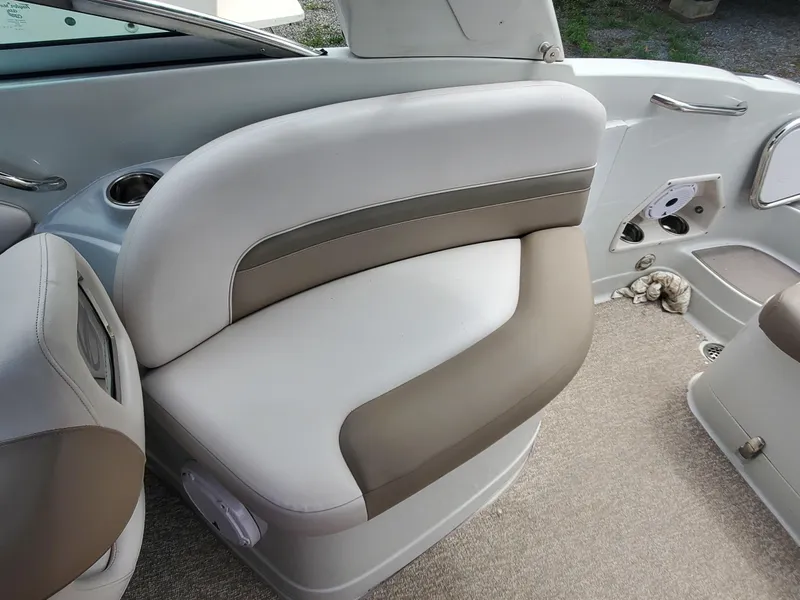 Slide: The Image of 2014 Crownline 285 SS boat interior seating with beige and white upholstery. - 9
