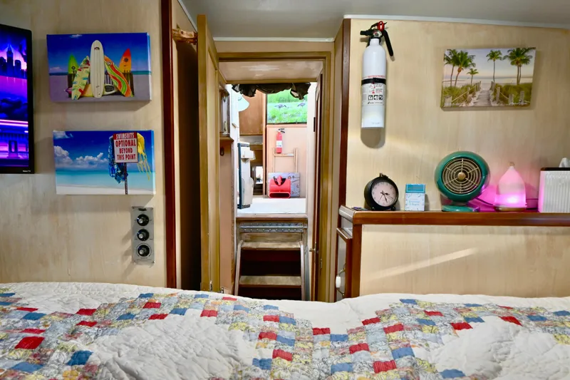 Slide: The Image of 1979 Uniflite Double Cabin interior with colorful decor and cozy bedding. - 13