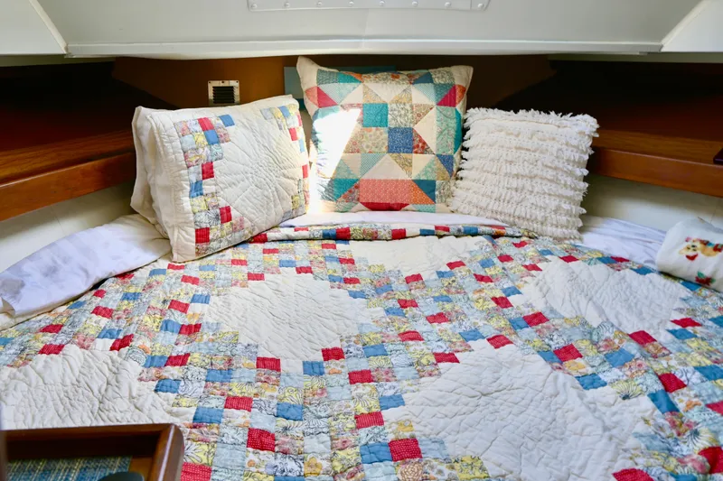 Slide: The Image of 1979 Uniflite Double Cabin interior with colorful patchwork quilt and pillows. - 15