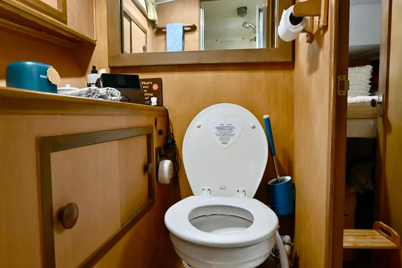 Slide: The Image of 1979 Uniflite Double Cabin bathroom with wooden cabinetry and toilet. - 19