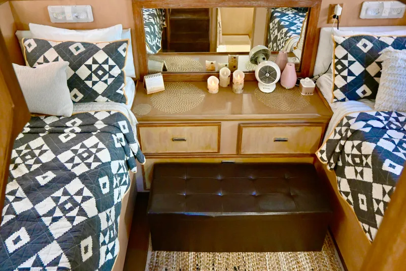 Slide: The Image of 1979 Uniflite Double Cabin interior with twin beds, geometric quilts, and wooden cabinetry. - 20