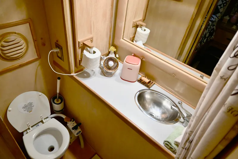Slide: The Image of 1979 Uniflite Double Cabin bathroom with toilet, sink, and toiletries. - 25
