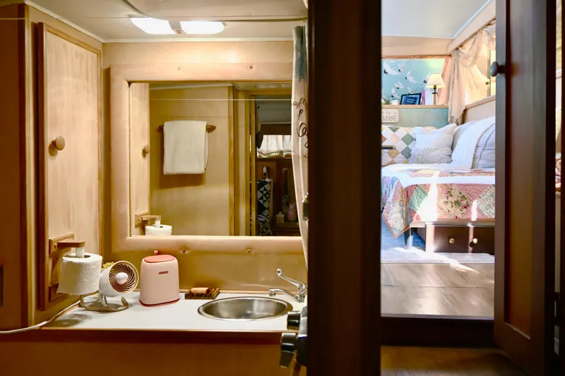 Slide: The Image of 1979 Uniflite Double Cabin interior with cozy bedroom and compact bathroom. - 26