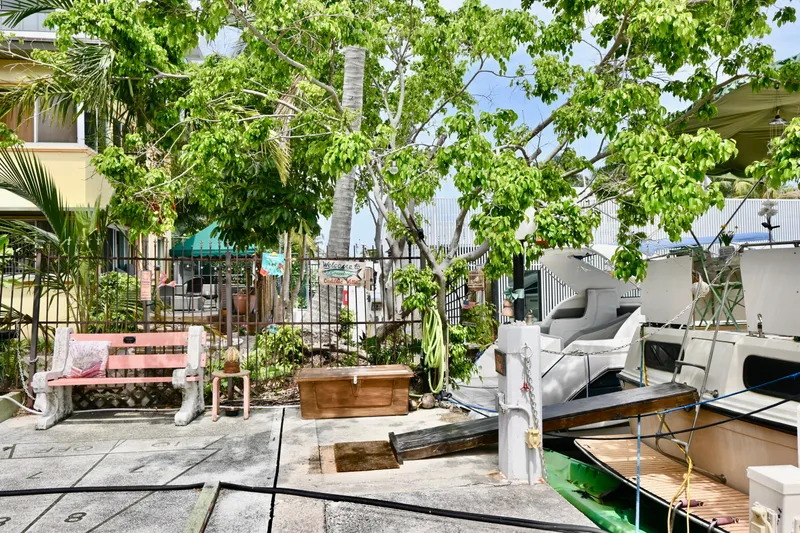 Slide: The Image of 1979 Uniflite Double Cabin docked near lush greenery and a pink bench. - 29