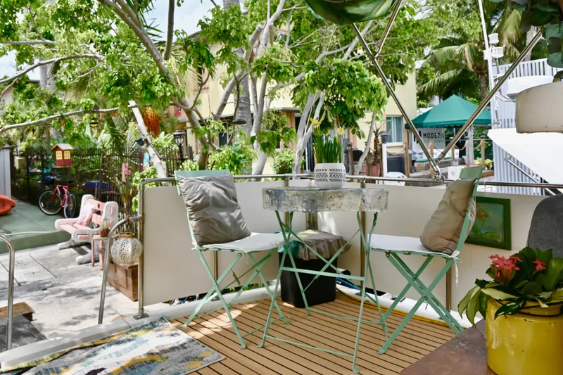 Slide: The Image of 1979 Uniflite Double Cabin with outdoor seating, surrounded by lush greenery and vibrant decor. - 6