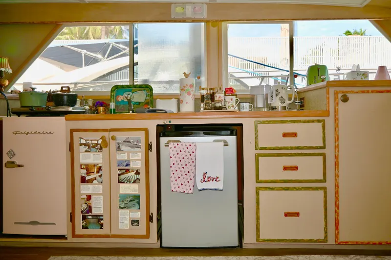 Slide: The Image of 1979 Uniflite Double Cabin kitchen with vintage decor, compact appliances, and nautical-themed accents. - 9