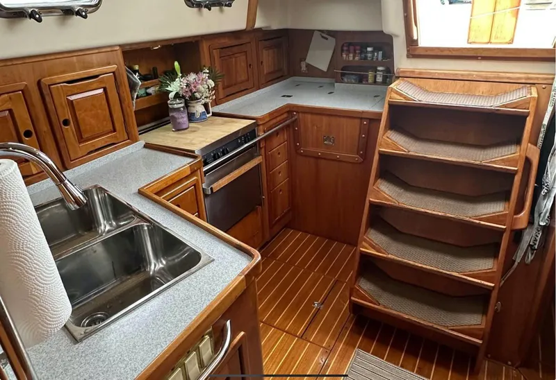 Slide: The Image of 2001 Saga 43 yacht kitchen with wooden cabinetry and stainless steel sink. - 4