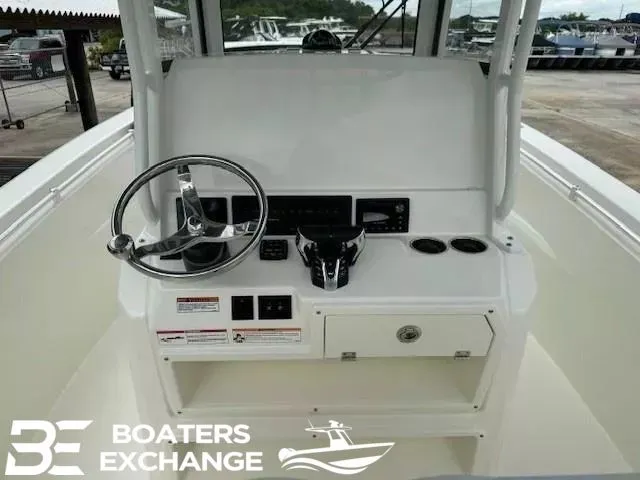 Slide: The Image of Cobia 265 Center Console 2025 helm with steering wheel and instruments. - 7